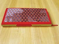 A red book with yellow back and a triangle-grid-structure