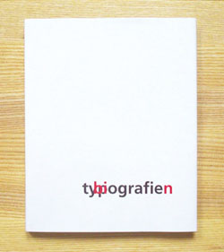 An all-white book with red and black layered words