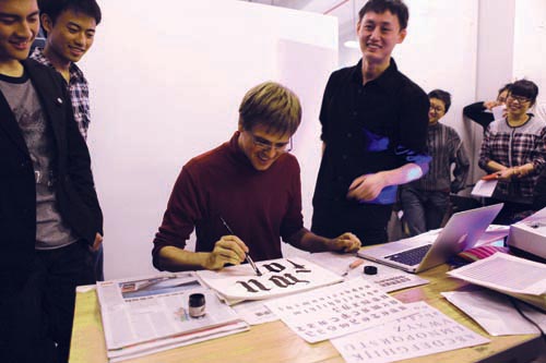 I am writing gothic letters by hand, while students watch