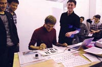 I am writing gothic letters by hand, while students watch