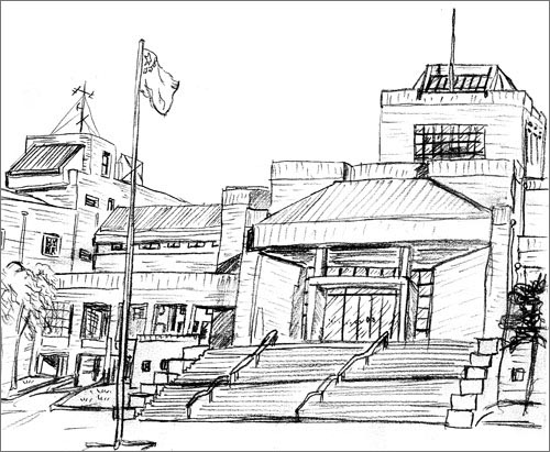 A building with huge stairs and a flagpole in front